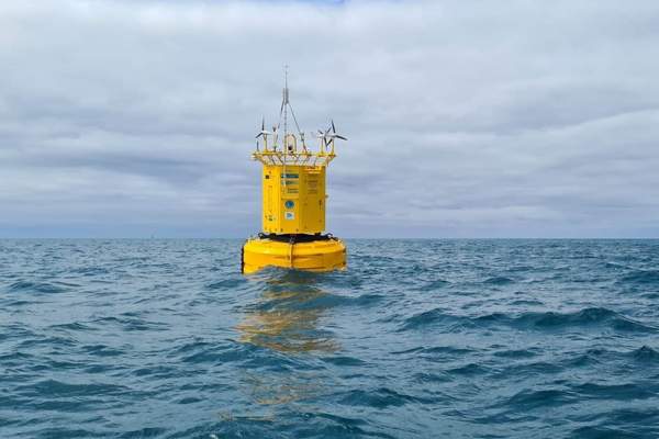 Yellow scientific data buoy at sea