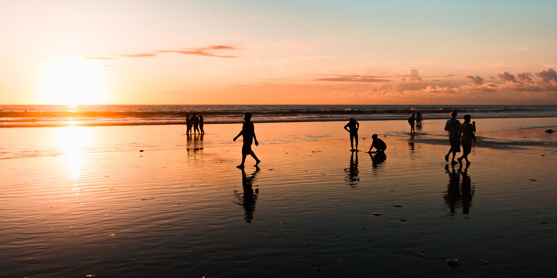 People on a beach at sunset