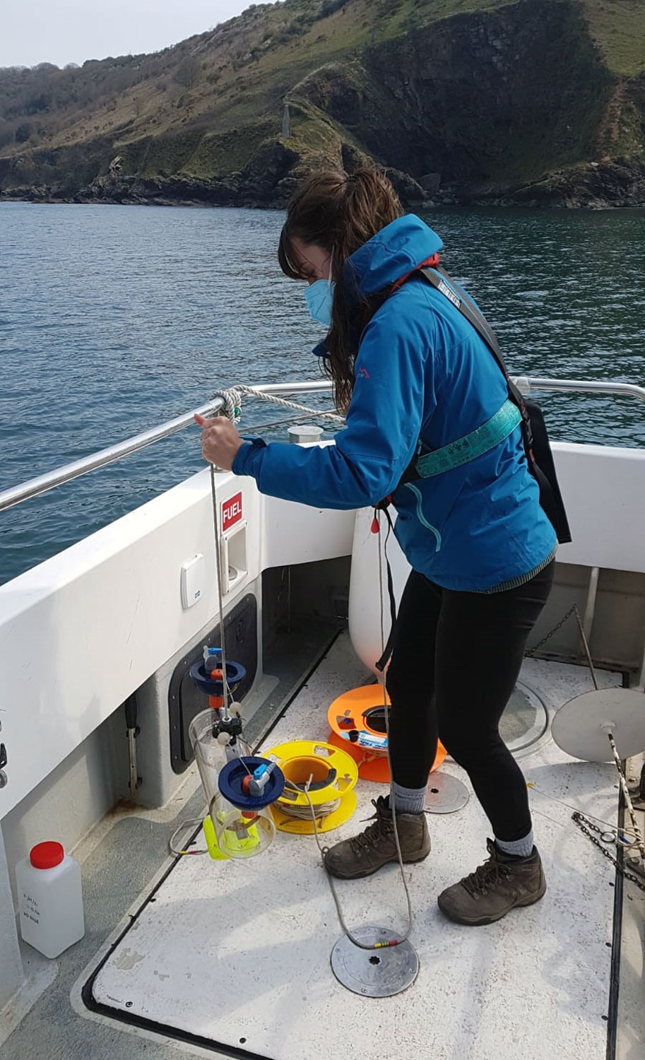 Jasmin deploying a Van Dorn water sampler in the Plymouth Sound during fieldwork with the University of Plymouth